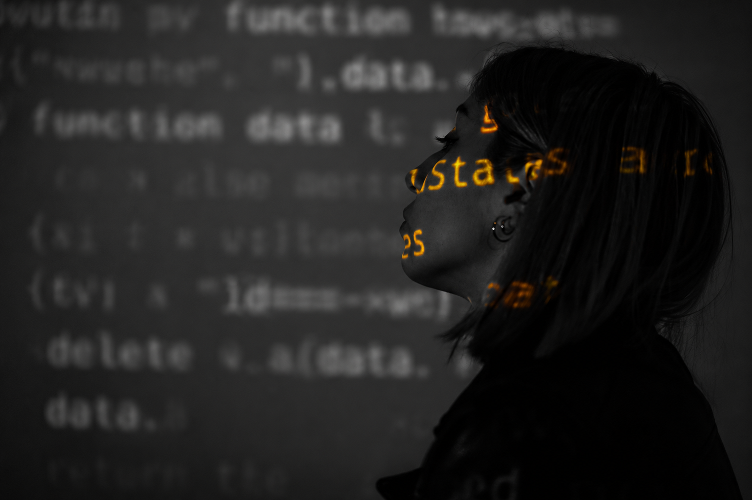 Woman's silhouette in profile with glowing digital code projected on her face, symbolizing AI in social media.